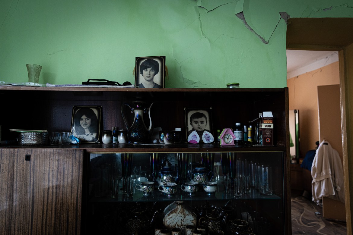 A wall of memorabilia and personal possessions in a damaged house