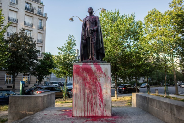 The statue of Hubert Lyautey, who served in Morocco, Algeria, Madagascar and Indochina when they were under French control, is offered with red painting Monday, June 22, 2020. Two statues related to France's colonial era were covered in graffiti Monday amid a global movement to take down monuments to figures tied to slavery or colonialism. (AP Photo/Rafael Yaghobzadeh)
