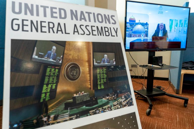Palestinian President Mahmoud Abbas is seen on a video screen outside the General Assembly hall as he addresses the the 76th Session of the United Nations General Assembly remotely, Friday, Sept. 24, 2021 at U.N. headquarters. (AP Photo/Mary Altaffer)
