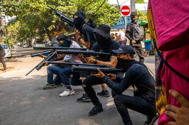 Protesters against the military coup in Myanmar line up with homemade air rifles during a demonstration in Yangon, Myanmar in April 2021 [File: AP Photo]