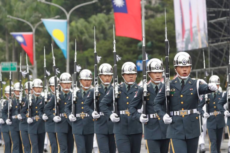 The military honor guard attend National Day celebrations in front of the Presidential Building in Taipei, Taiwan, Monday, Oct. 10, 2022. (AP Photo/Chiang Ying-ying)