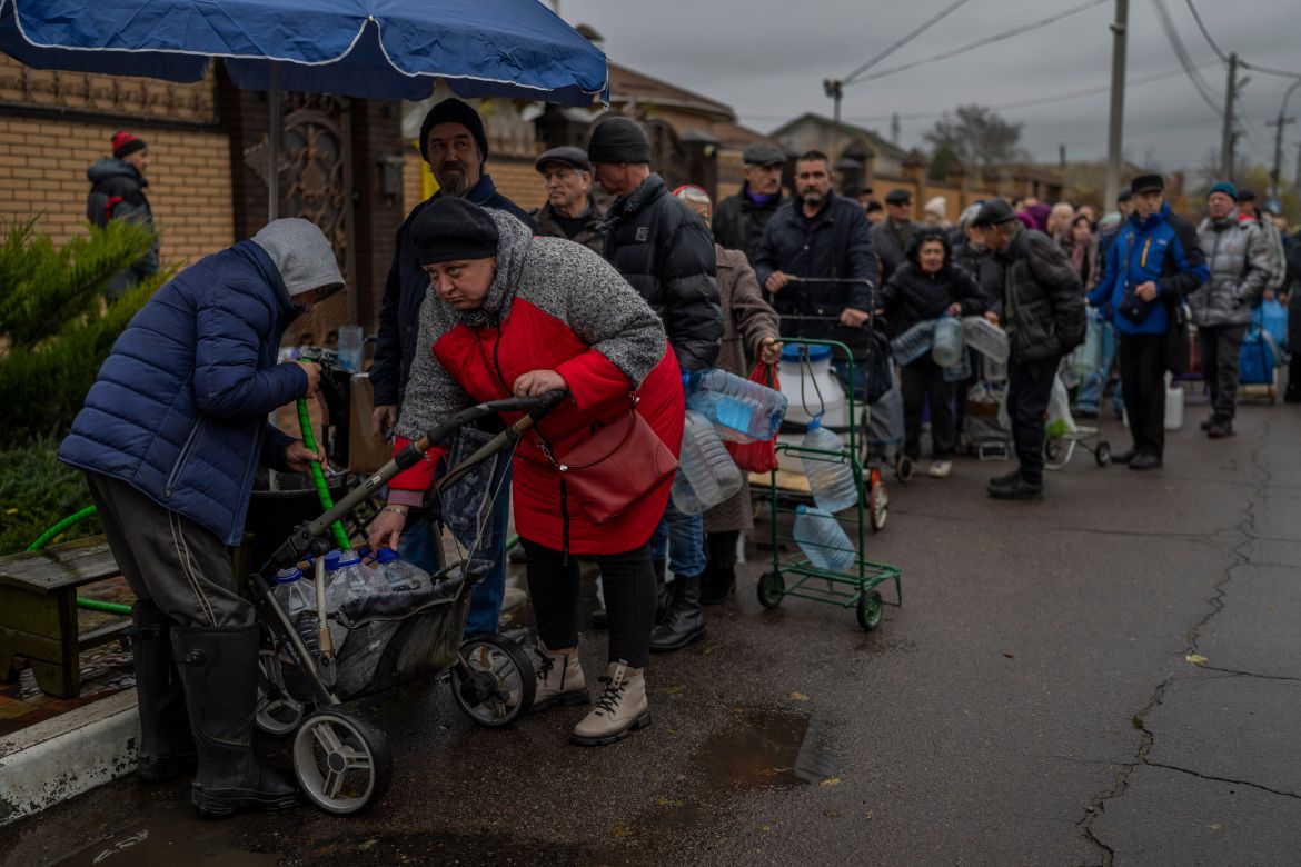 Residents queue to fill containers with drinking water in Kherson, southern Ukraine, Sunday, Nov. 20, 2022. (AP Photo/Bernat Armangue)