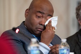 Democratic National Committee chair Jaime Harrison wipes away tears as committee member Donna Brazile delivers an impassioned speech in favour of changes to the Democrat’s presidential nomination process [Nathan Howard/AP Photo]