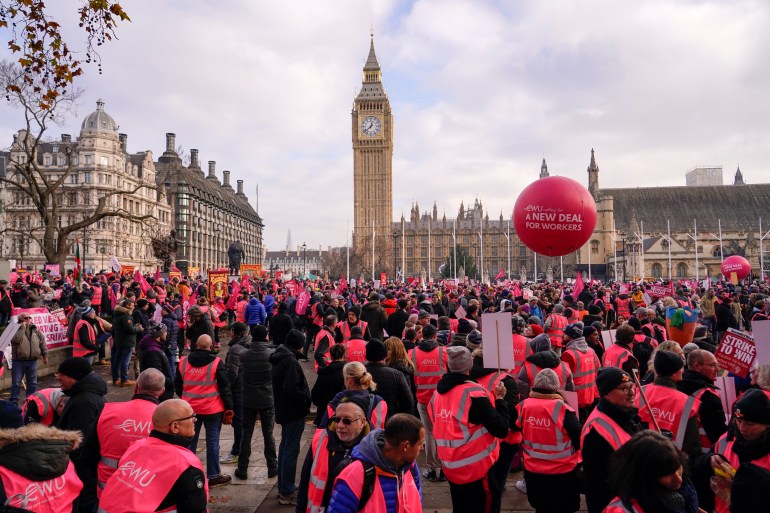 Royal Mail workers gather in Parliament Square, as they hold a pay and employment rally, in London, Friday, December 9, 2022. Communications Workers Union (CWU) planned a six-day pay strike.  (AP photo/Alberto Pezzali)