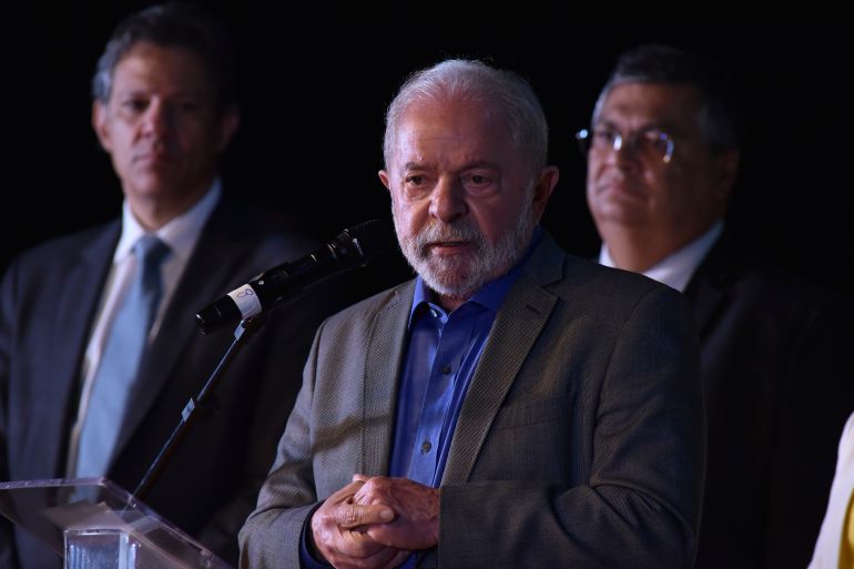 Luiz Inacio Lula da Silva stands beside future cabinet ministers