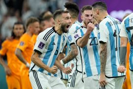 Argentina players celebrate during the penalty shootout in the World Cup quarterfinal soccer match between the Netherlands and Argentina