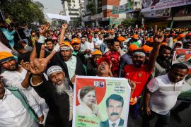 Supporters of the Bangladesh Nationalist Party shout slogans and hold placards during a demonstration.
