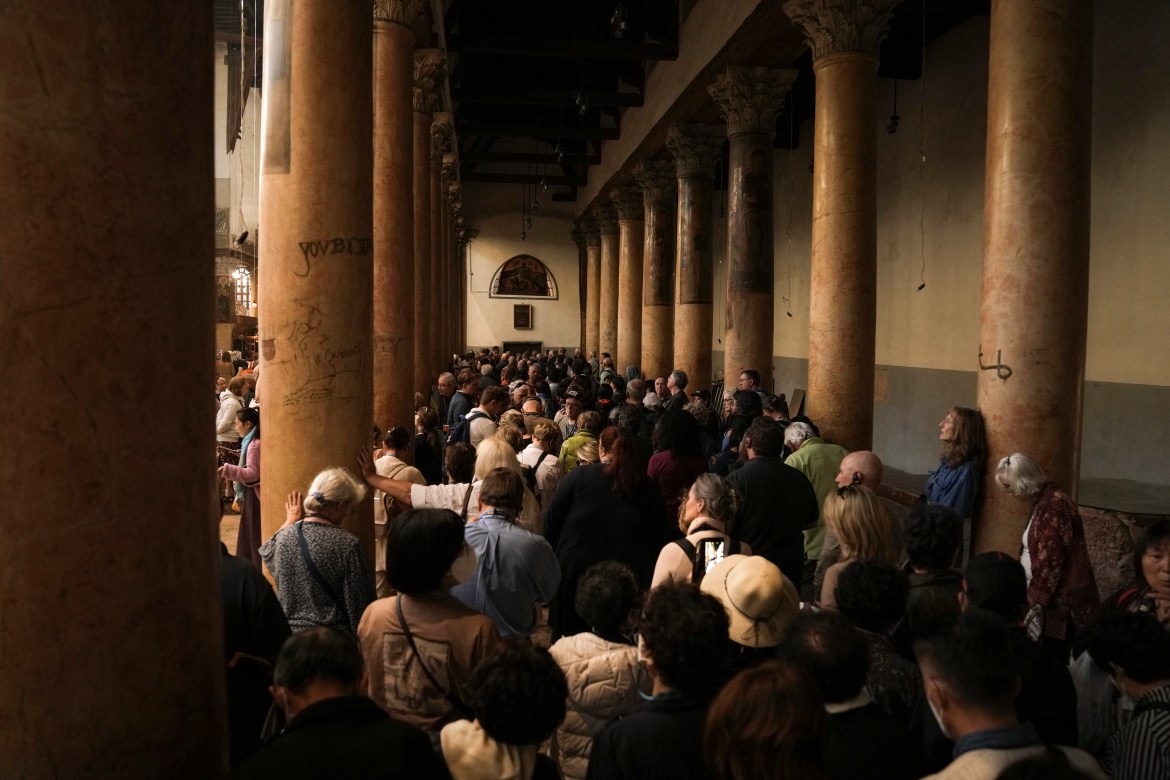 Tourists visit the Church of the Nativity,