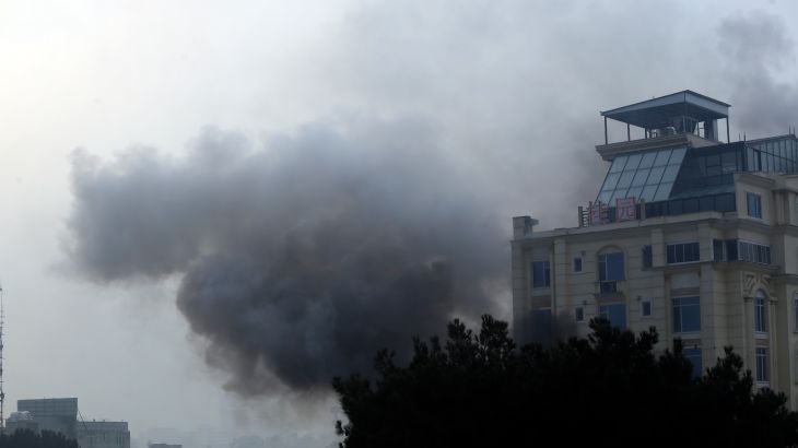 Smoke rises from a hotel building after an explosions and gunfire in the city of Kabul