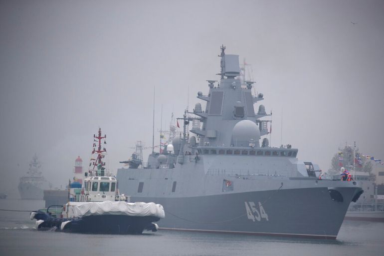 FILE - A tugboat escorts the Russian frigate Admiral Gorshkov as it prepares to dock at a port in Qingdao in eastern China's Shandong Province, Sunday, April 21, 2019. China says Chinese-Russian naval drills beginning Wednesday aim to “further deepen" cooperation between the sides whose unofficial anti-Western alliance has gained strength since Moscow's invasion of Ukraine. (AP Photo/Mark Schiefelbein, File)