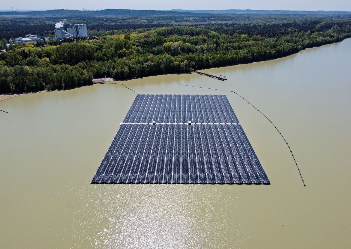 Solar panels on Germany's biggest floating photovoltaic plant produce energy under a blue sky