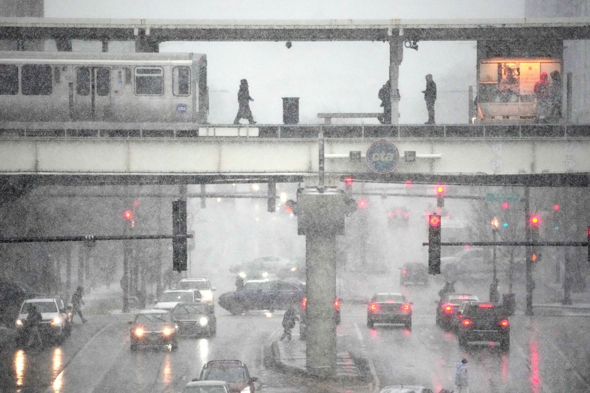 A Chicago Transit Authority train arrives at the Roosevelt train station as the leading edge of a winter storm begins in Chicago