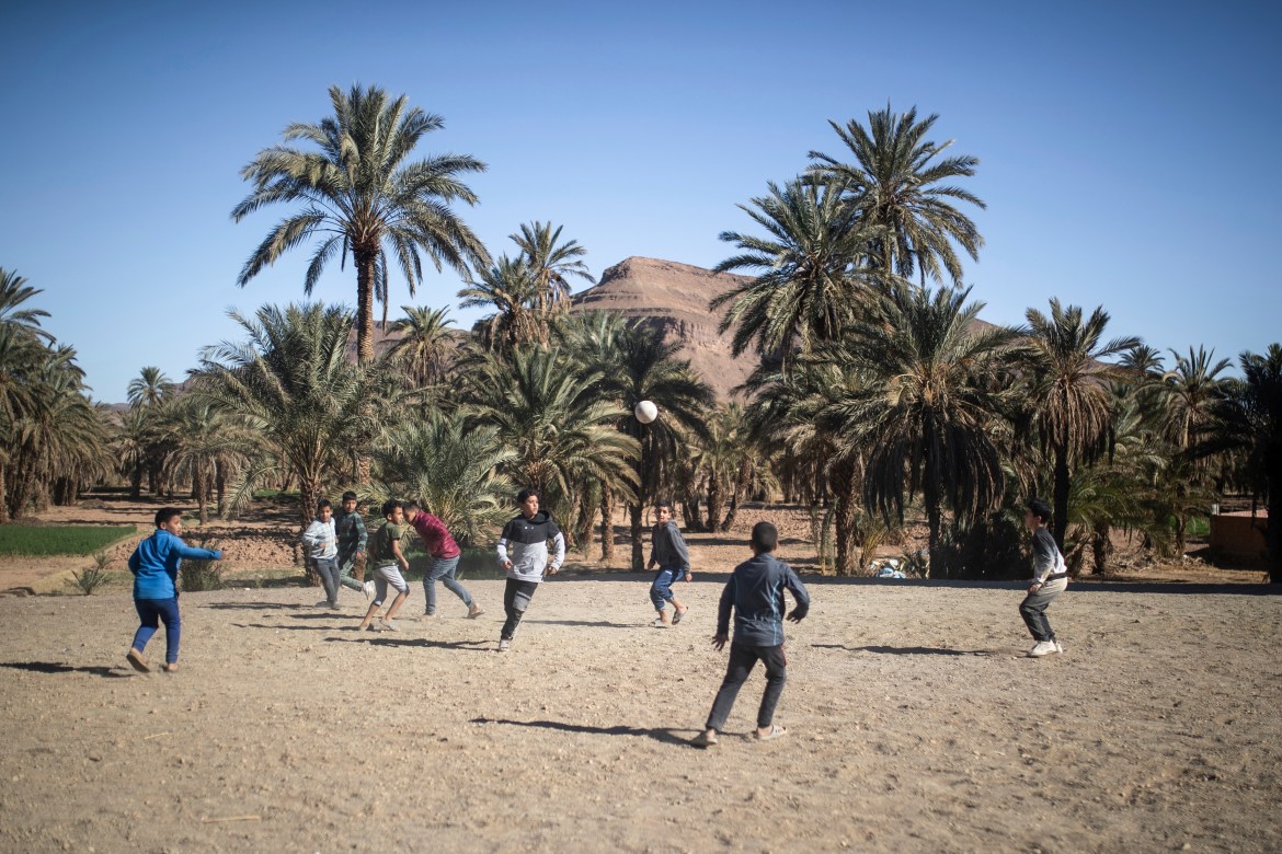 Boys play football in the Alnif oasis town,