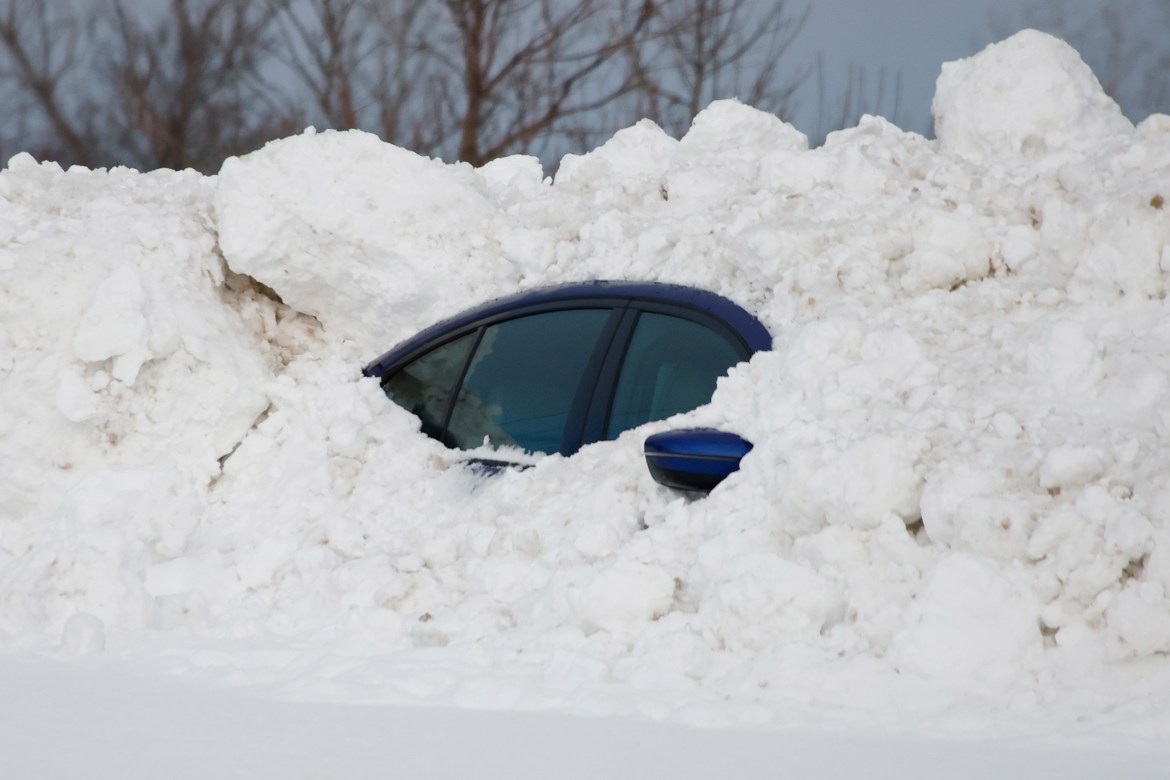 A car sits burried after a winter storm