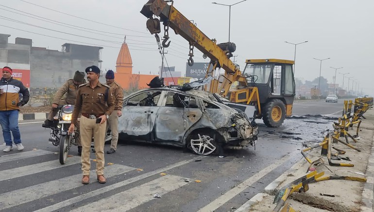 Policemen investigate the scene of a car accident near Roorkee, in the northern Indian state of Uttarakhand, Friday, Dec. 30, 2022. Indian cricketer Rishabh Pant, 25, was driving the car that overturned and caught fire after hitting a road divider, Ravi Bijaria, a state government spokesman said. Pant, who was alone at the time of the accident, was hospitalized on Friday with non life-threatening injuries. (AP Photo)