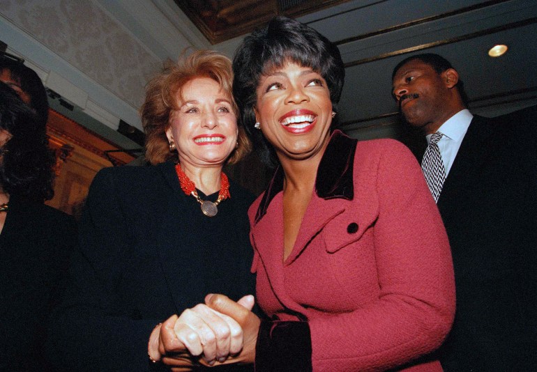 FILE - Oprah Winfrey is greeted by Barbara Walters, left, as she arrives at the Plaza Hotel in New York, November 11, 1994. Barbara Walters, the intrepid interviewer, host, and broadcaster who became the first woman to become a television news superstar during a network career notable for its duration and variety, passed away on Friday, December 30, 2022. She was 93. (AP Photo/Clark Jones, File)