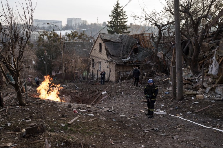 Emergency workers arrive at a residential area hit during a Russian attack in Kyiv,