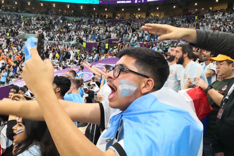 Abdur Rahman, from Bahrain, celebrating with thousands of Argentina fans as the side won against Netherlands in a penalty shootout to reach the World Cup semifinals on Friday, December 9, 2022 [Hafsa Adil/Al Jazeera]