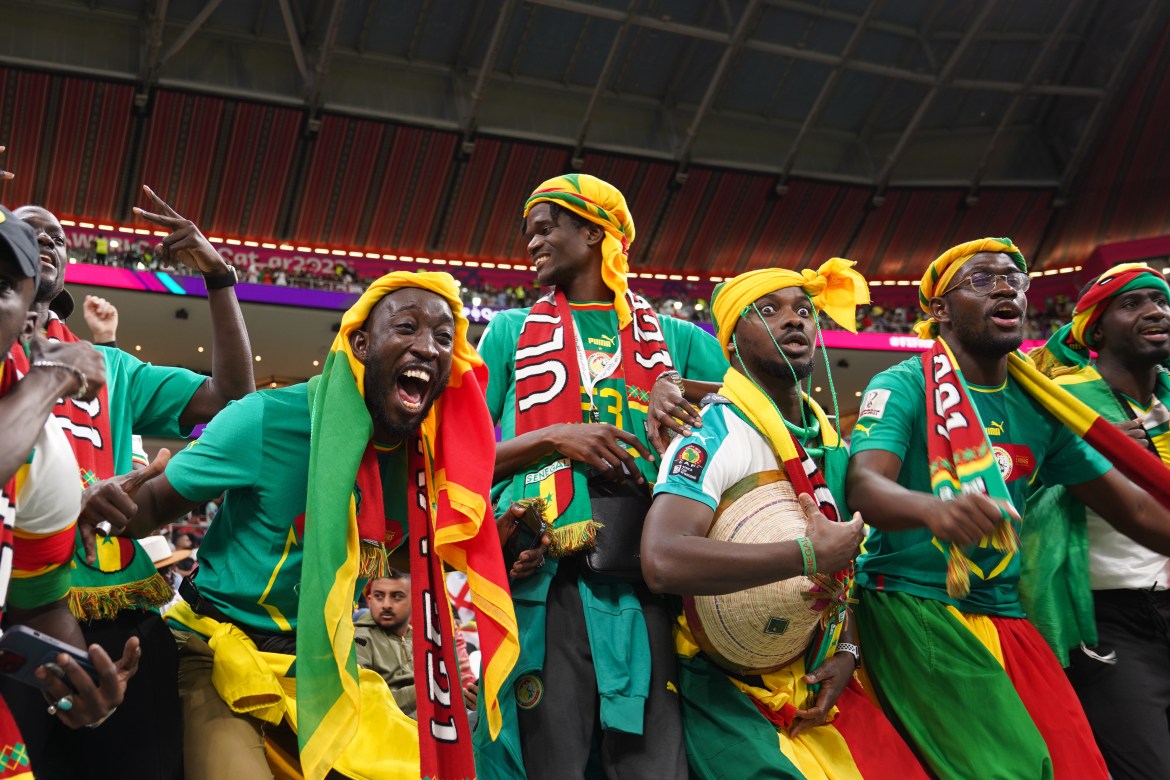 Senegal fans celebrate in the stands before the match.