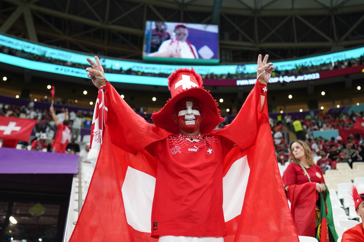 Switzerland fans celebrate in the stands before the match.