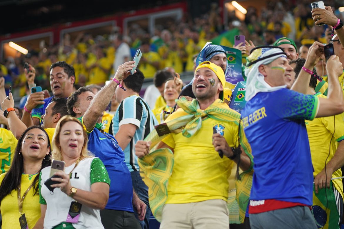 Brazil fans celebrate their team's fourth goal in the first half of the match against South Korea.