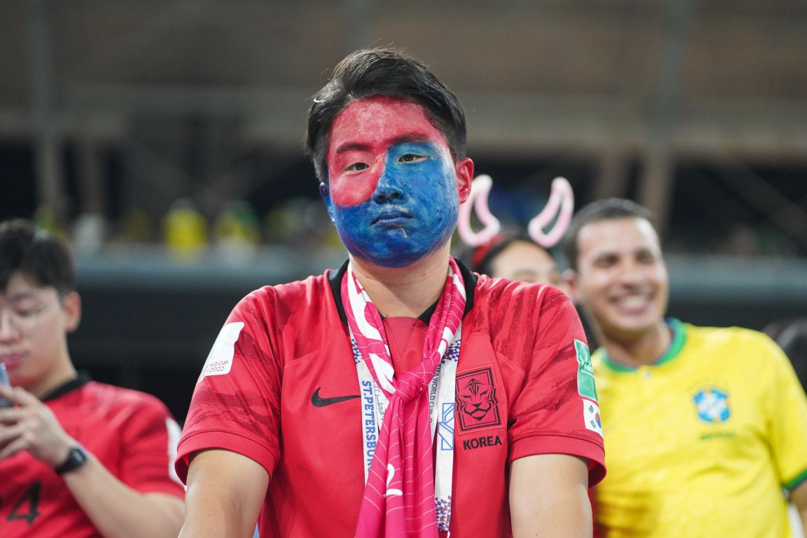A seemingly dejected Korea fan watches his side down 4-0 at the half.