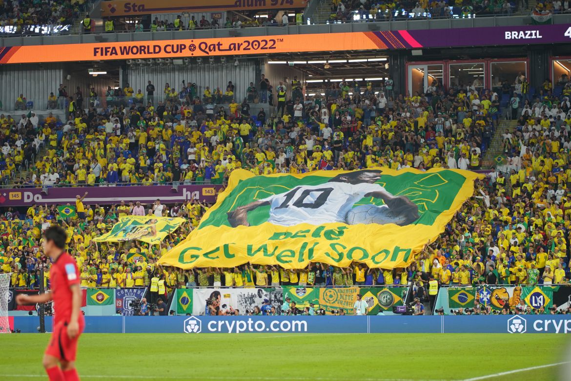 A huge Pele banner is unfurled in the stands. It reads: "Pele, get well soon."