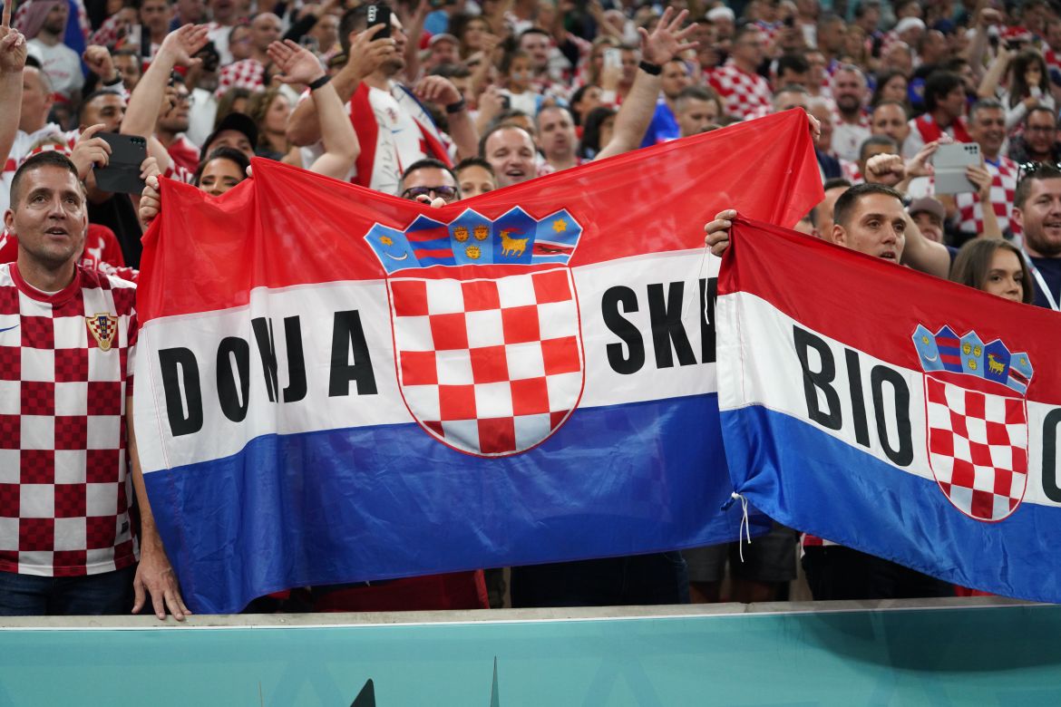 Croatia fans celebrate in the stands with a Croatian flag before the match.
