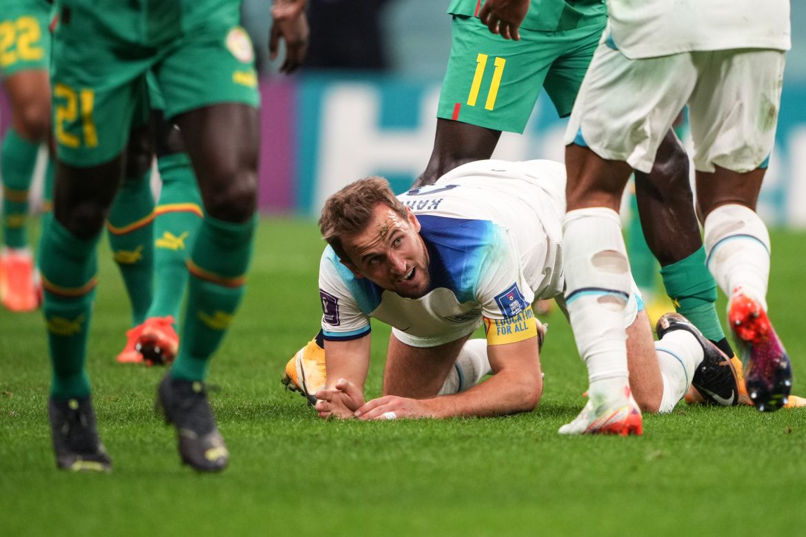 Harry Kane down on all fours on the pitch.