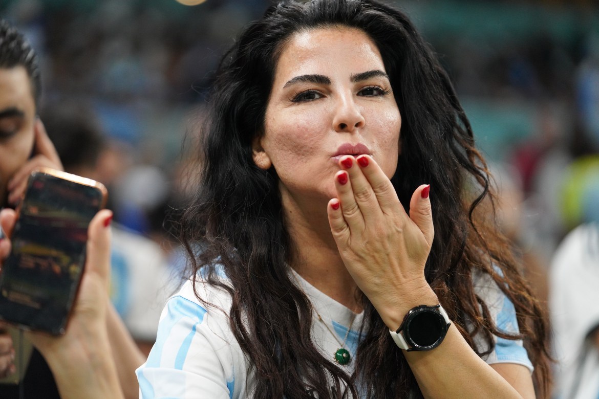 A woman, clearly an Argentina fan, blows kisses to the camera.