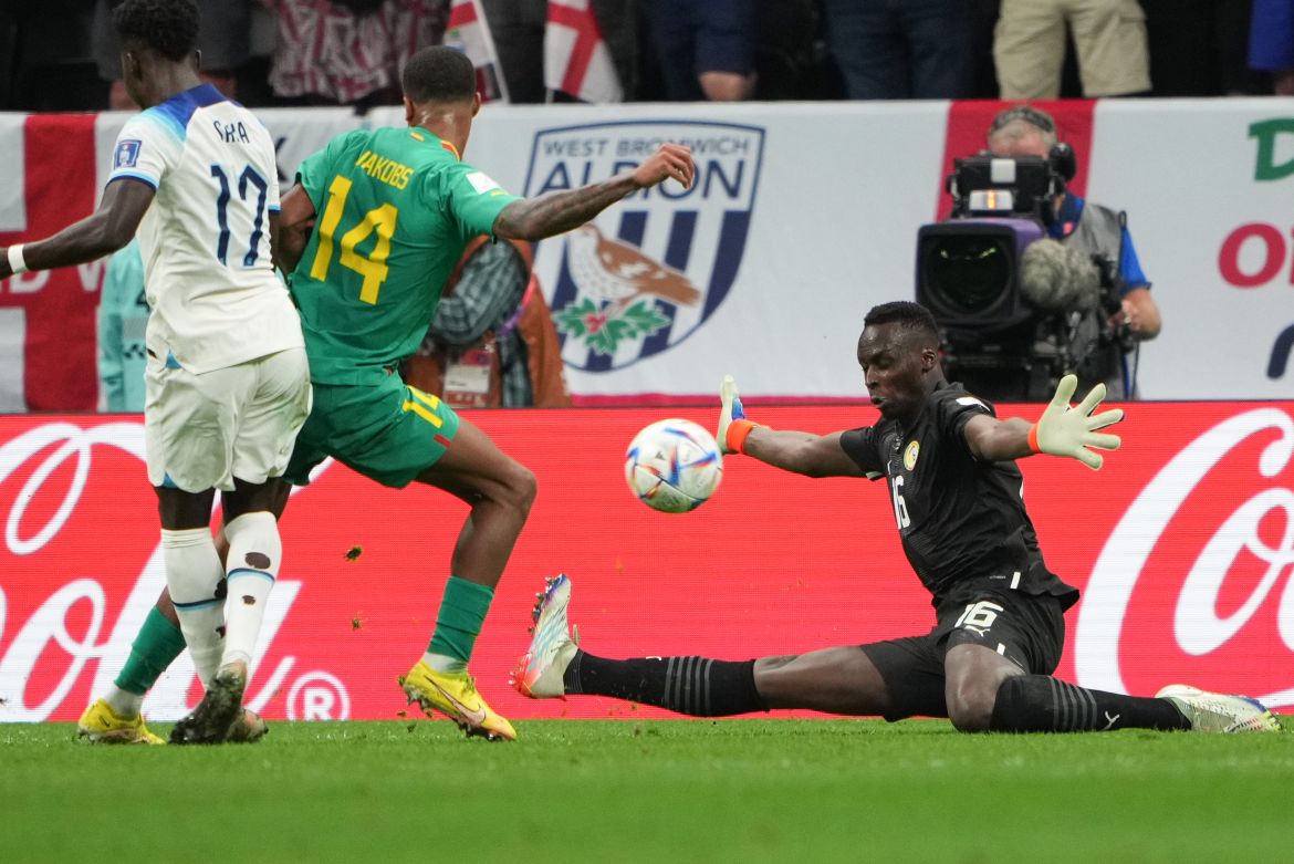 Saka scores as the Senegal keeper watches the ball sail past him.