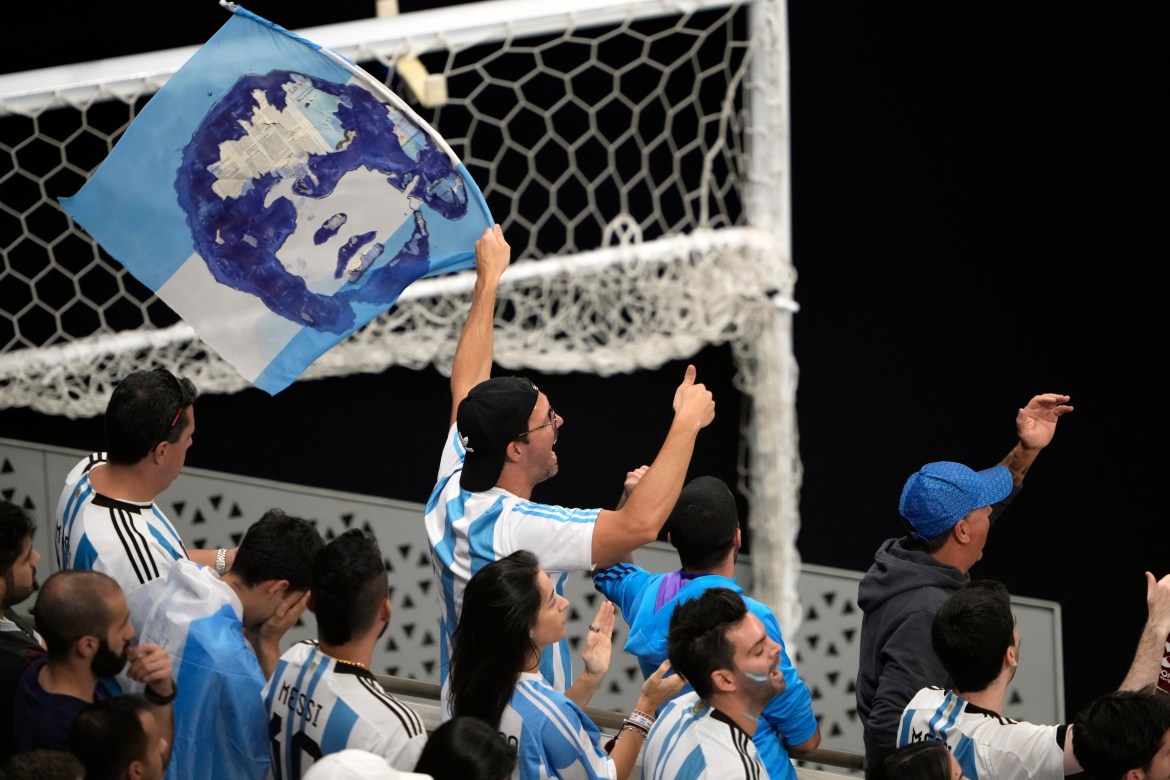 Argentina fan waving a flag with the face of legend Diego Maradona.