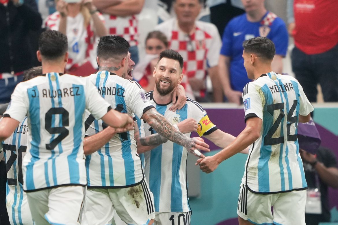 Messi celebrates with his teammates after putting Argentina ahead.