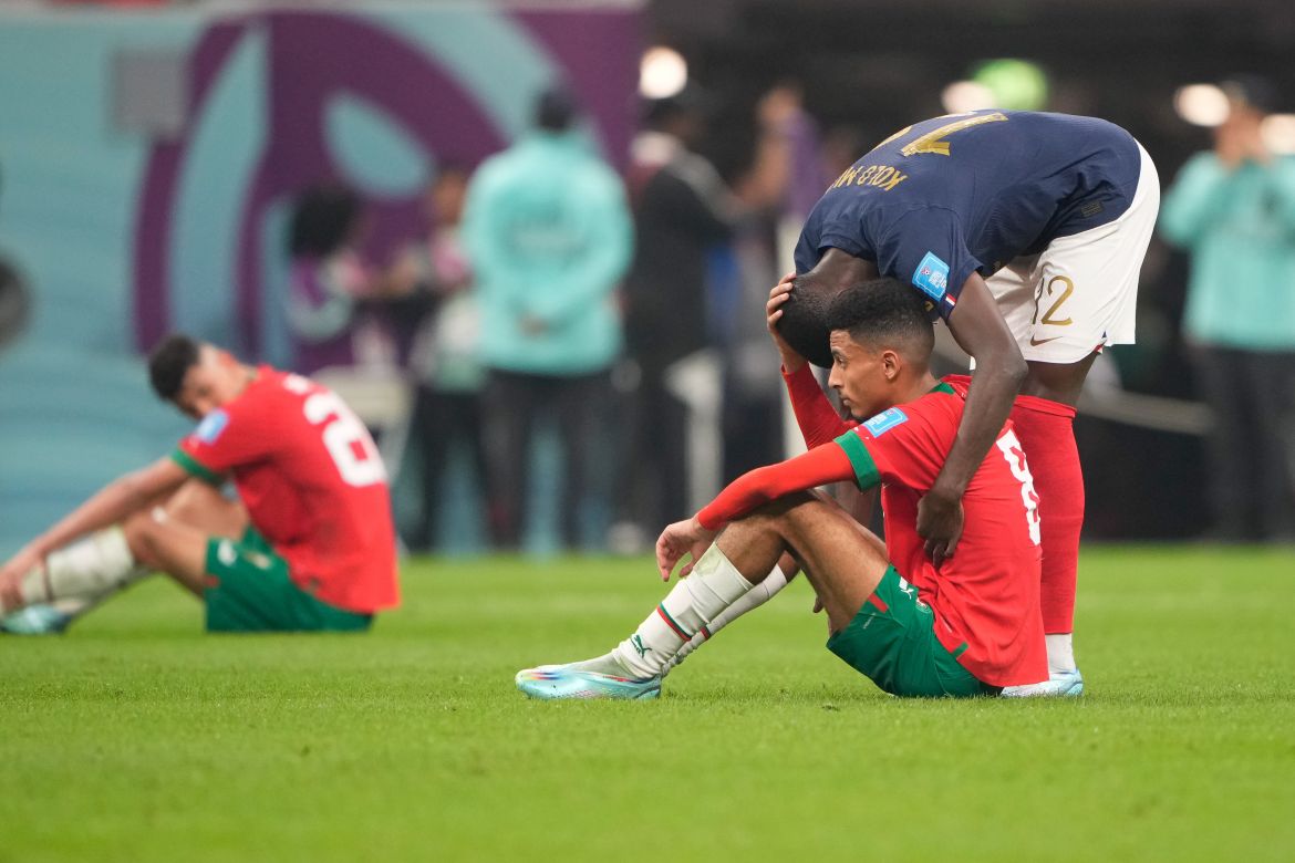Randal Kolo Muani #12 comforts Moroccan player