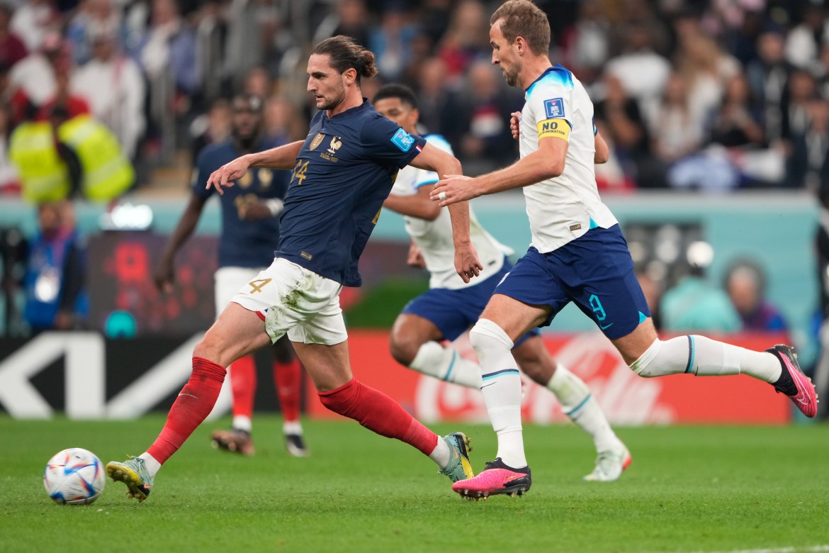 Harry Kane #9 in action with Adrien Rabiot #14