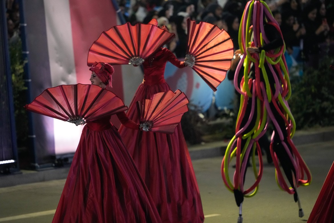 Stilt walkers take part in the victory parade.