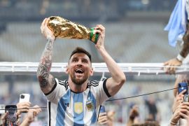 Lionel Messi holds the World Cup aloft after his side's victory over France | Argentina v France