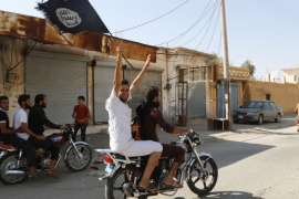 A man on a bike raises the ISLI (ISIS) flag.