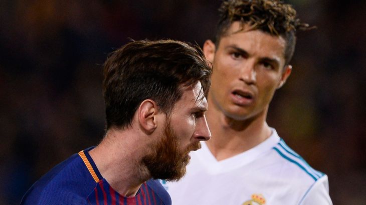 Real Madrid's Portuguese forward Cristiano Ronaldo (R) looks at Barcelona's Argentinian forward Lionel Messi during the Spanish league football match between FC Barcelona and Real Madrid CF at the Camp Nou stadium in Barcelona on May 6, 2018.