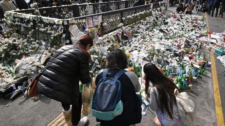 Mourners pay tributes at a makeshift memorial for the victims of the deadly Halloween crowd surge, outside a subway station in the district of Itaewon in Seoul on November 1, 2022