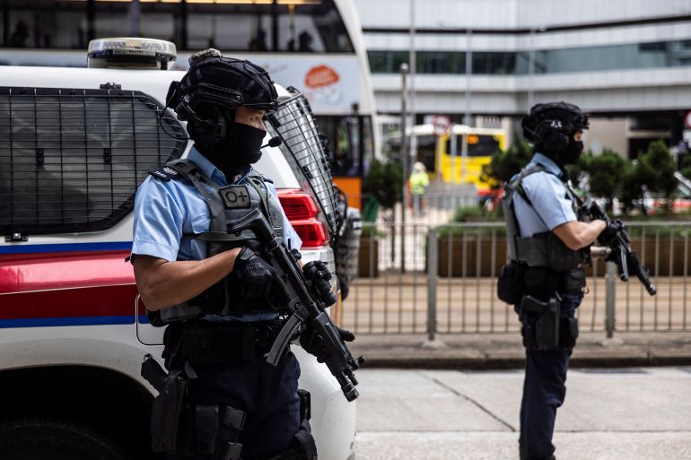 Armed police stand guard outside a Hong Kong court ahead of an appearance by media tycoon Jimmy Lai