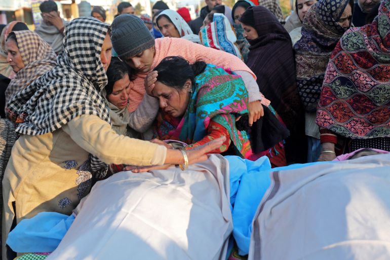 EDITORS NOTE: Graphic content / Family members mourn next to the bodies of residents who were killed after two gunmen suspected to be anti-India rebels opened fire on houses in the remote village of Dangri in Rajouri district on January 2, 2023