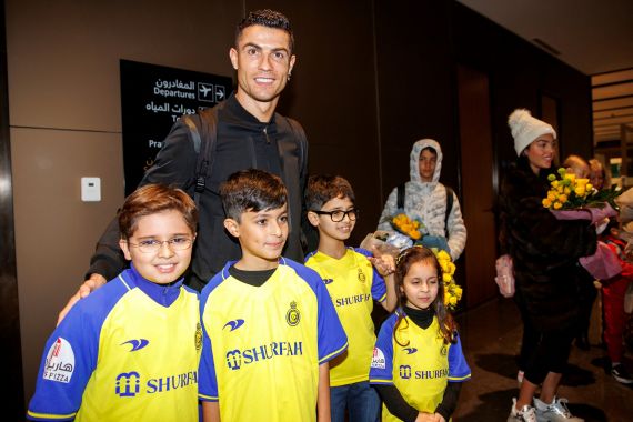 Portugal's Cristiano Ronaldo posing for pictures with Saudi kids upon his arrival at a private airport in Riyadh, Saudi Arabia.