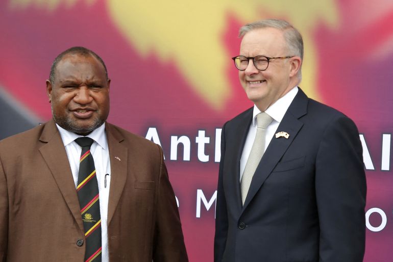Papua New Guinea's Prime Minister James Marape (L) and his Australian counterpart Anthony Albanese pose for photos prior to their bilateral meeting in Port Moresby on January 12, 2023. - Albanese called for a "swift" new security deal with Papua New Guinea, as his government seeks to parry China's expanding influence in the Pacific. (Photo by ANDREW KUTAN / AFP)