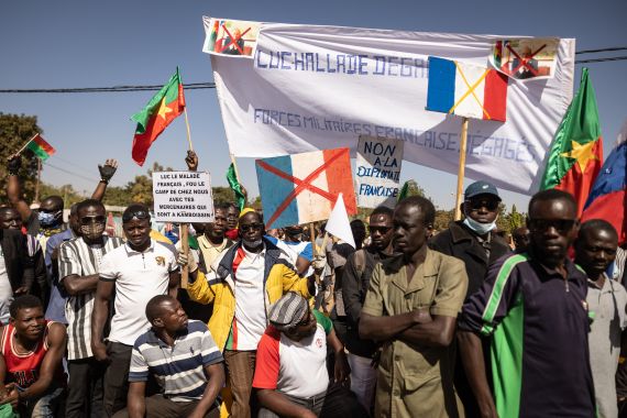 Demonstrators hold placards during a protest to support Burkina Faso's president, Captain Ibrahim Traore, and to demand the departure of France's ambassador and military forces, in Ouagadougou, on January 20, 2023.
