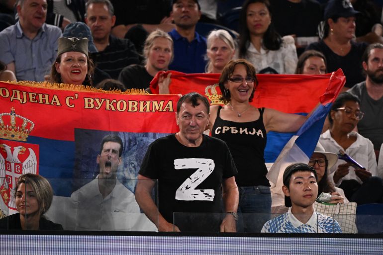 A man wearing a "Z" T-shirt watches the men's singles quarter-final match between Serbia's Novak Djokovic and Russia's Andrey Ruble on day ten of the Australian Open tennis tournament in Melbourne on January 25, 2023.