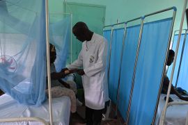 Professor Vagamon Bamba, centre, visits leprosy patients at the Raoul Follereau Institute near Adzope. [Issouf Sanogo/AFP]