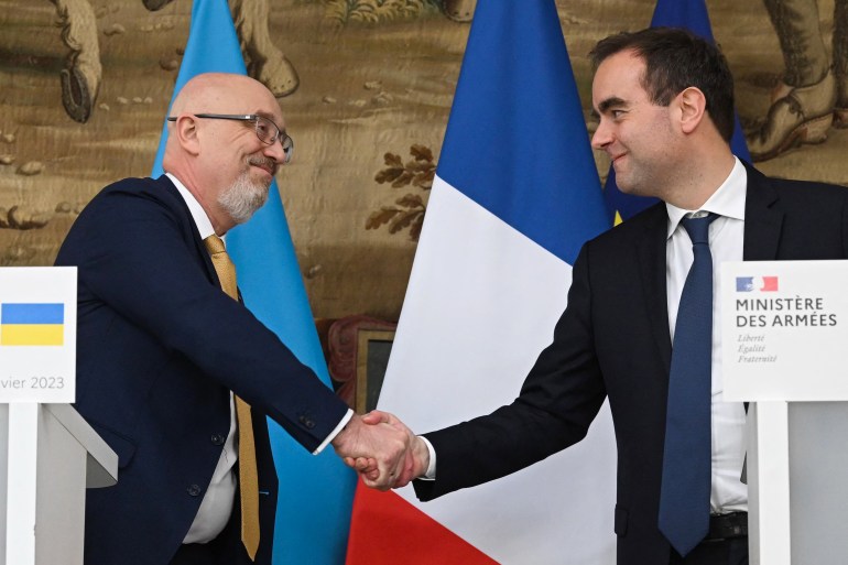French and Ukrainian defence ministers shaking hands