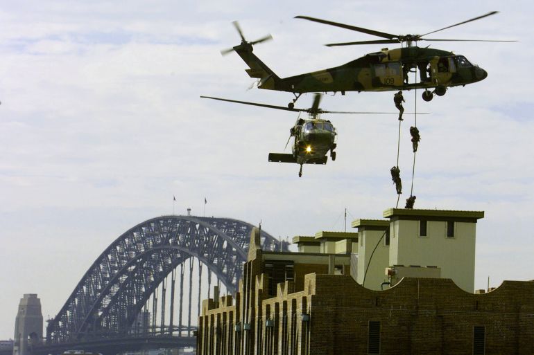 Members of Australia's Special Forces Counter Terrorist squad abseil from Black Hawk helicopter in Sydney, Australia