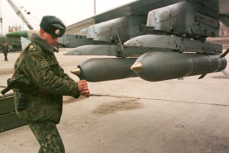 Russian ground staff officer fixes detonators on bombs attached to a jet at a military airfield in Mozdok, in Ossetia December 20. Prime Minister Vladimir Putin said December 22 the military campaign in rebel Chechnya was near its end and Interfax news agency said commanders had received orders and were ready to take the capital Grozny. Picture taken December 20. CVI/AA
